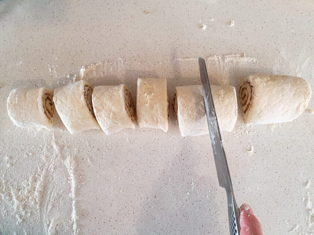 Slicing up rolls with a sharp knife.