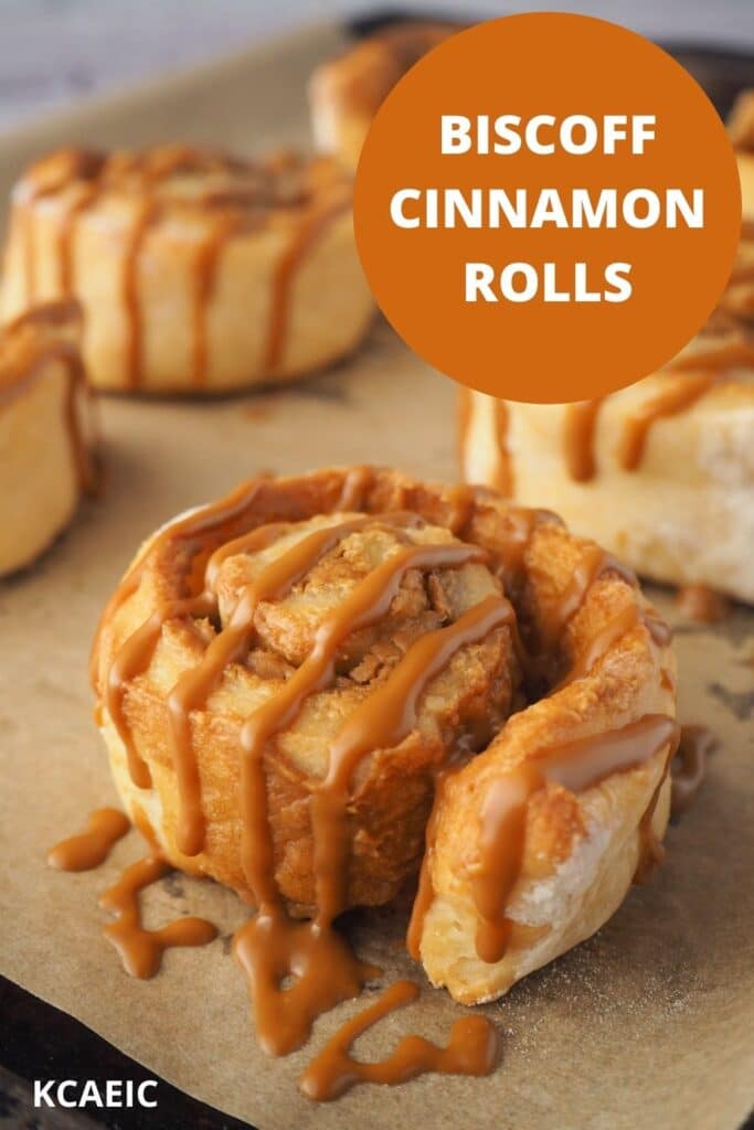 Biscoff roll drizzled with Biscoff on a baking tray, with text overlay, Biscoff Cinnamon Rolls, KCAEIC.