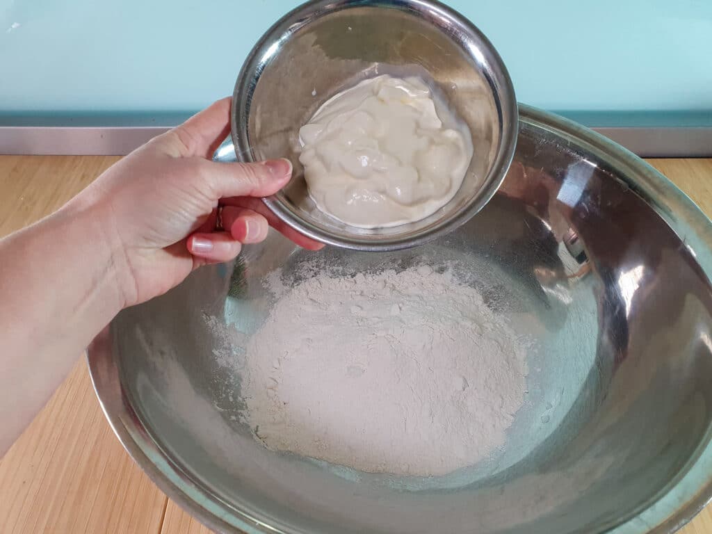 Adding yogurt to flour.