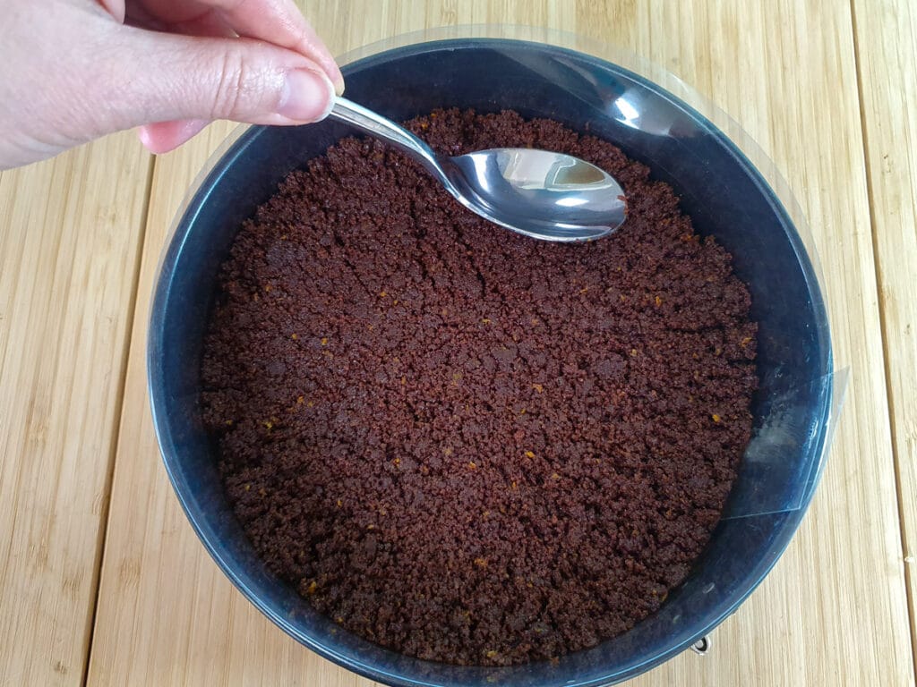 Chocolate Orange Cheesecake 9 Pressing down the base mix into the lined tin.