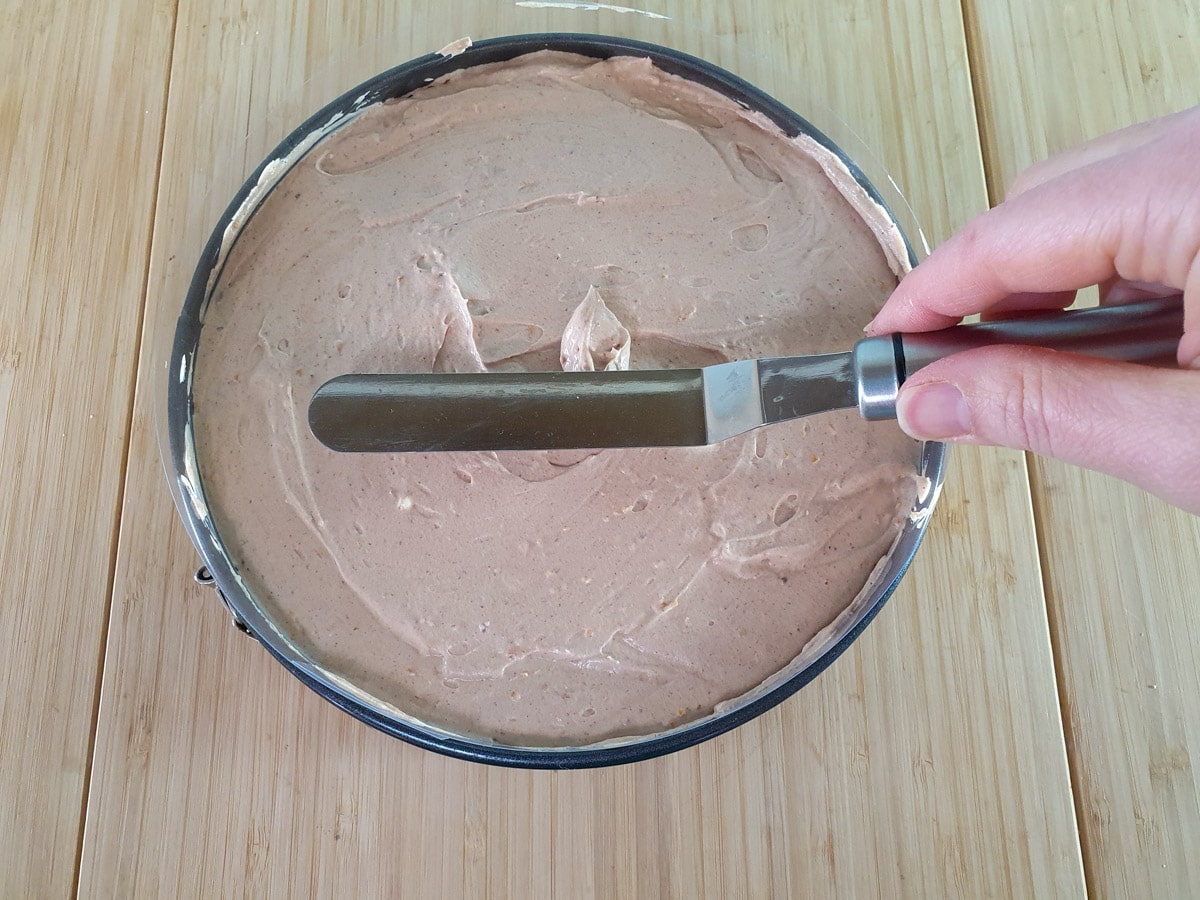 Smoothing down the cheesecake filling.