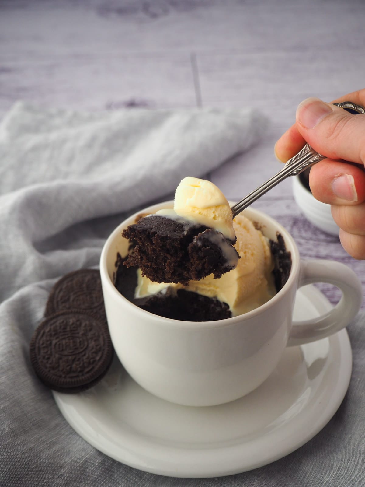 Oreo Mug Cake 18 Eating cake with a scoop of ice cream