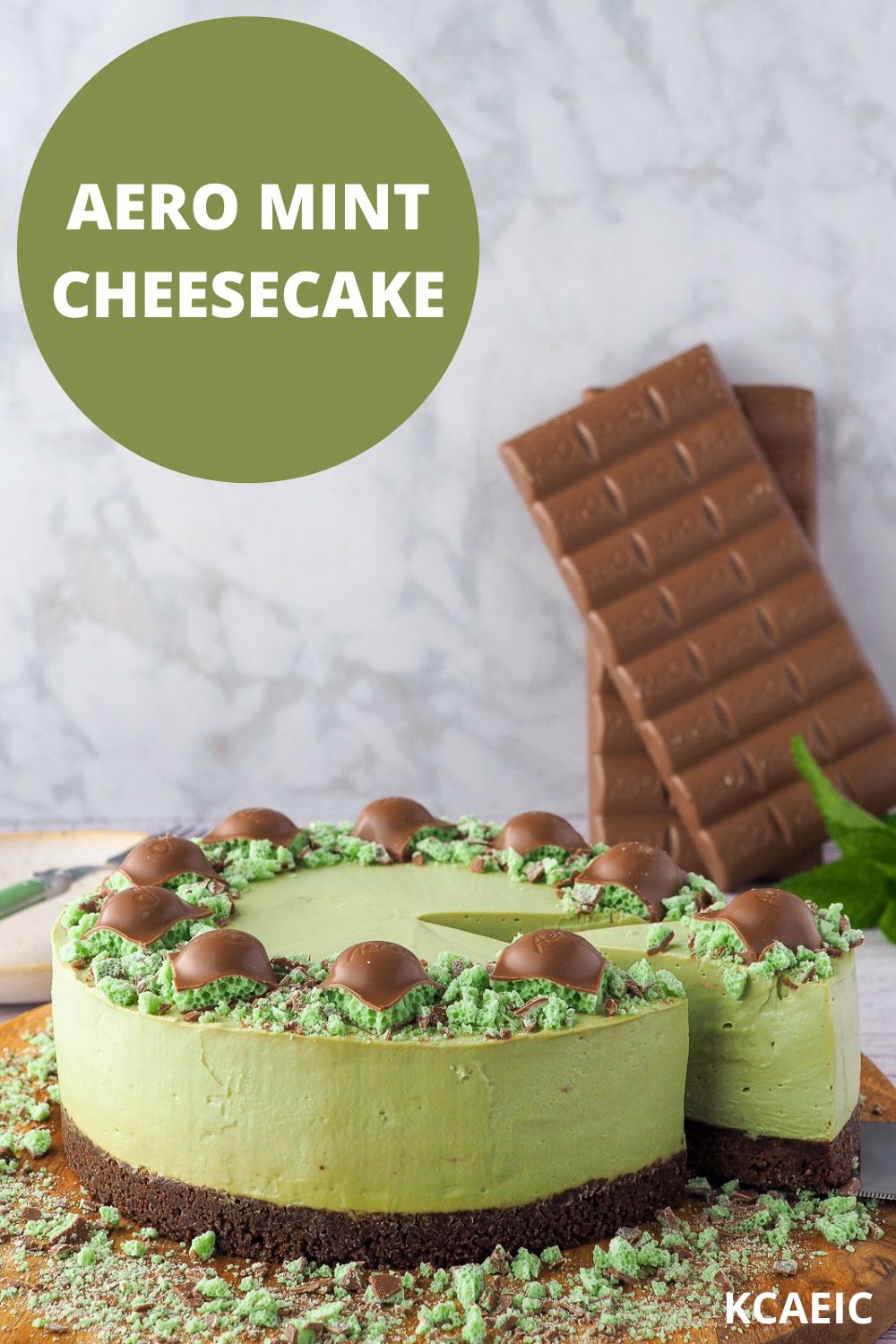 Aero Mint Cheesecake 11 Slice of cheesecake being taken out, with chocolate and mint in background, with text overlay, Aero mint cheesecake, KCAEIC.