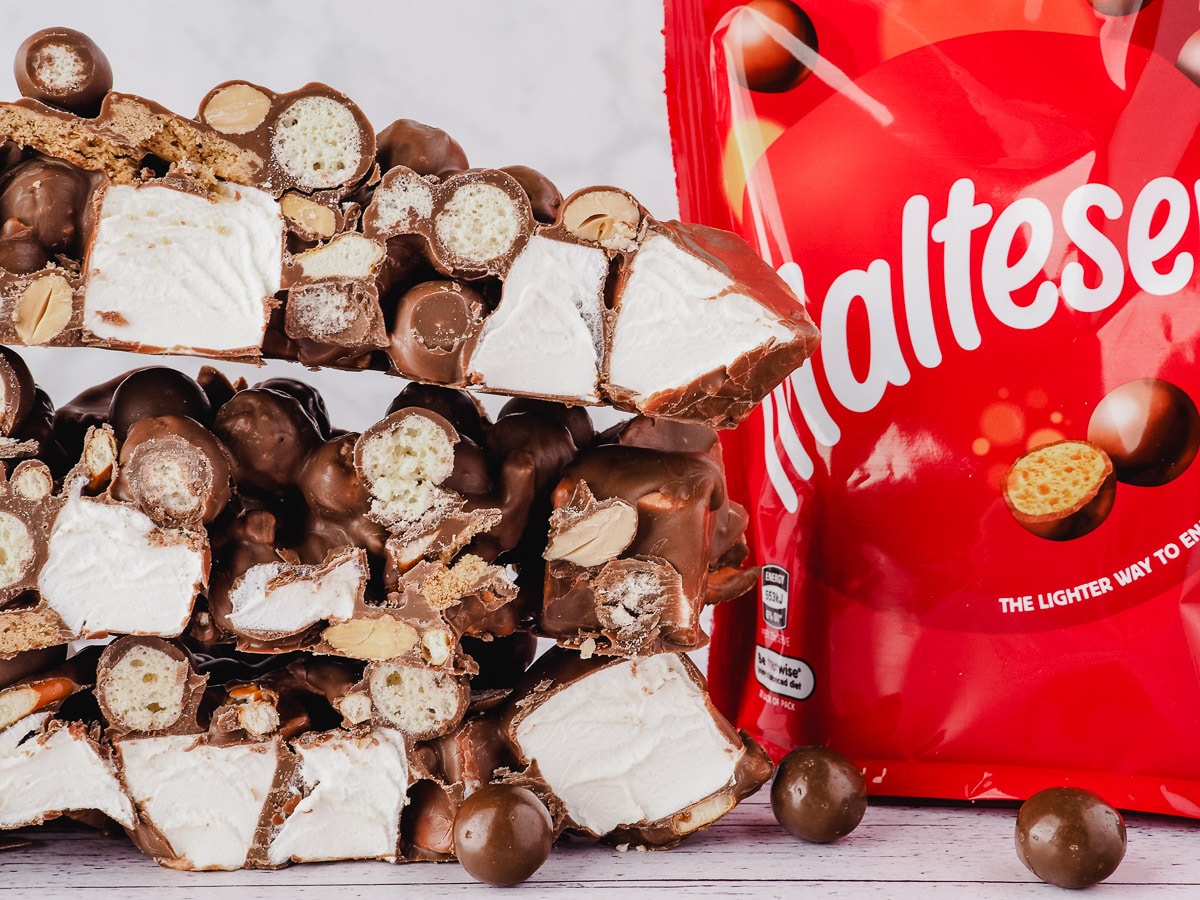 Stack of rocky road with Malteser packet to the side.