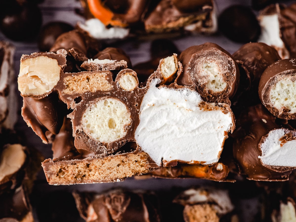 Maltesers Rocky Road 7 Slice of rocky road on its side, surrounded by other pieces.