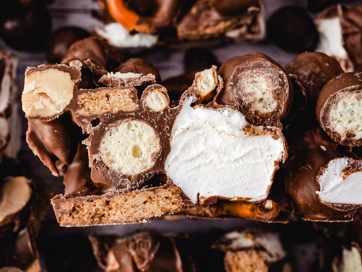 Slice of rocky road on its side, surrounded by other pieces.