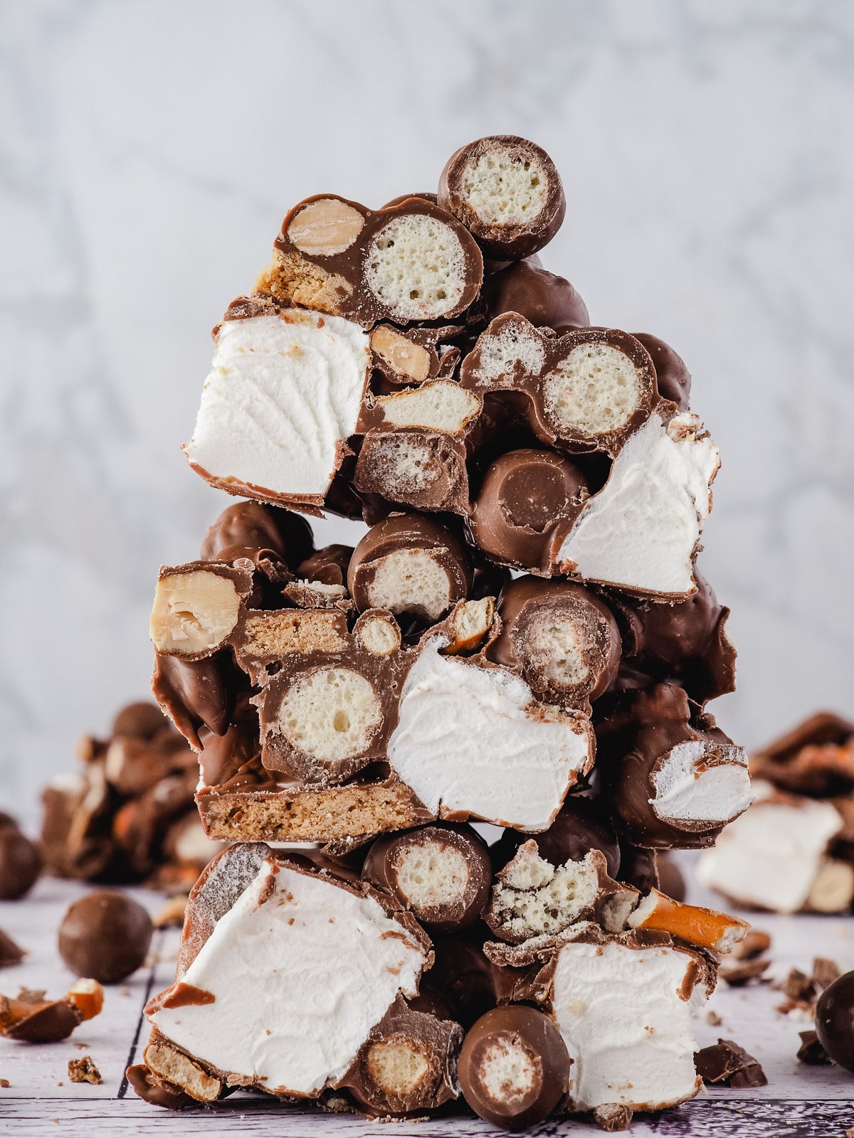 Stack of rocky road with Malteser balls in the background.