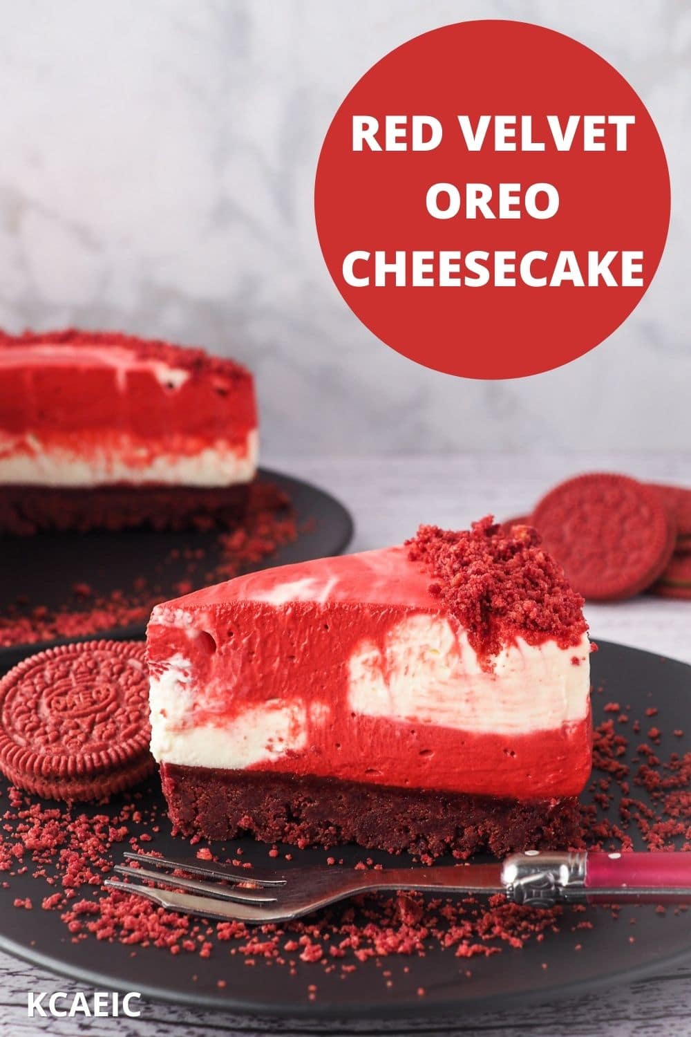 Cheesecake on a plate with fork, Oreo crumbs, with rest of cake and Oreos in background, with text overlay Red Velvet Oreo Cheesecake and KCAEIC.