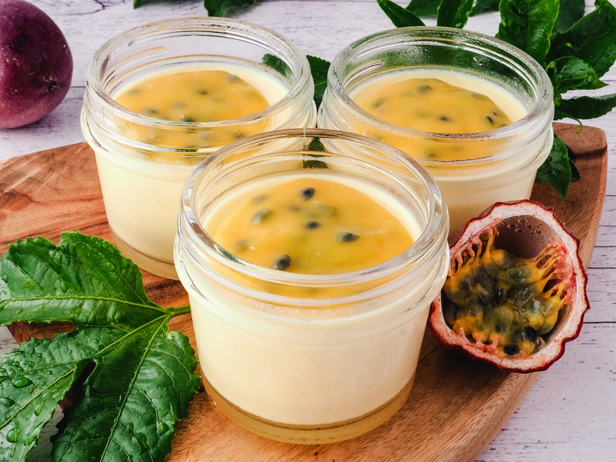 3 pots of passion fruit panna cotta topped with curd.