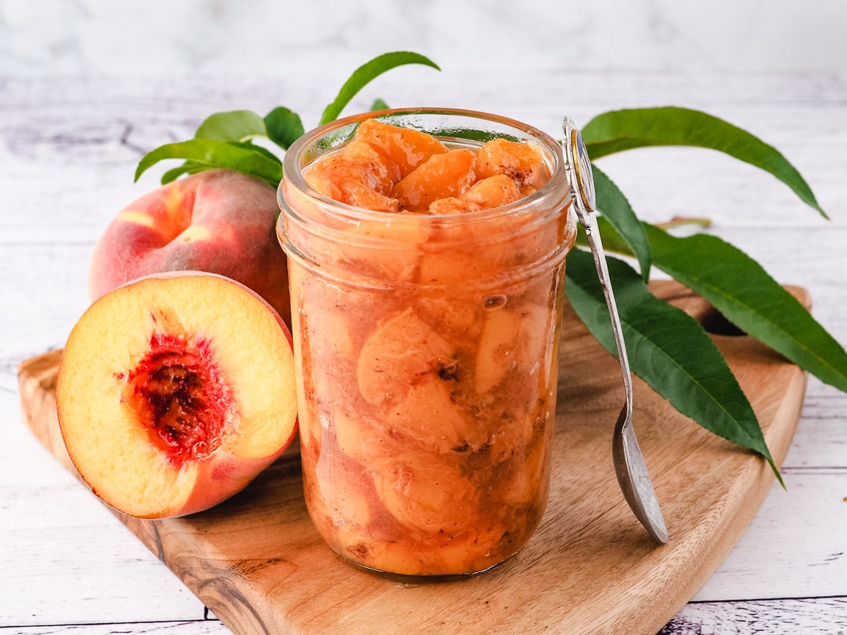 Peach compote 2 Compote in a mason jar with a spoon