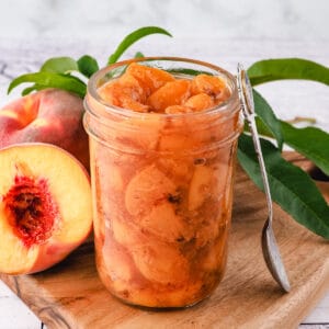 Compote in mason jar with spoon.