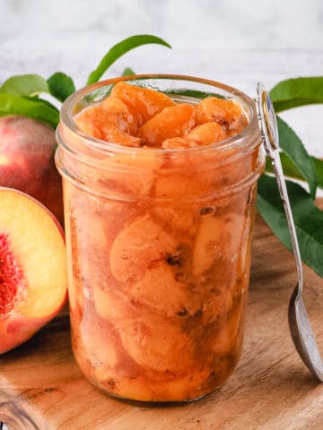 Compote in mason jar with spoon.