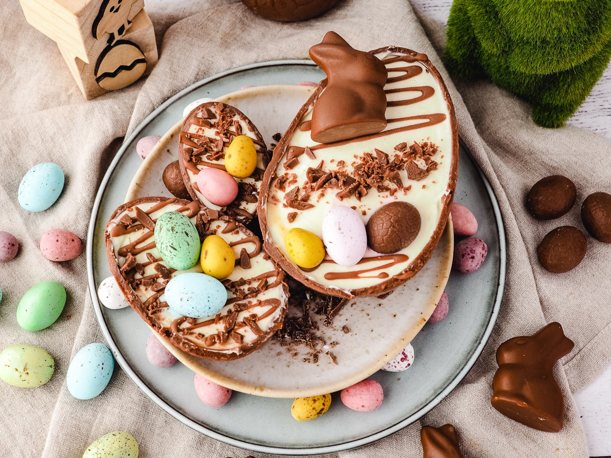 Large, medium and small Easter egg cheesecakes on a plate.