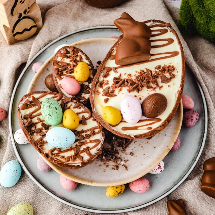 Large, medium and small Easter egg cheesecakes on a plate.