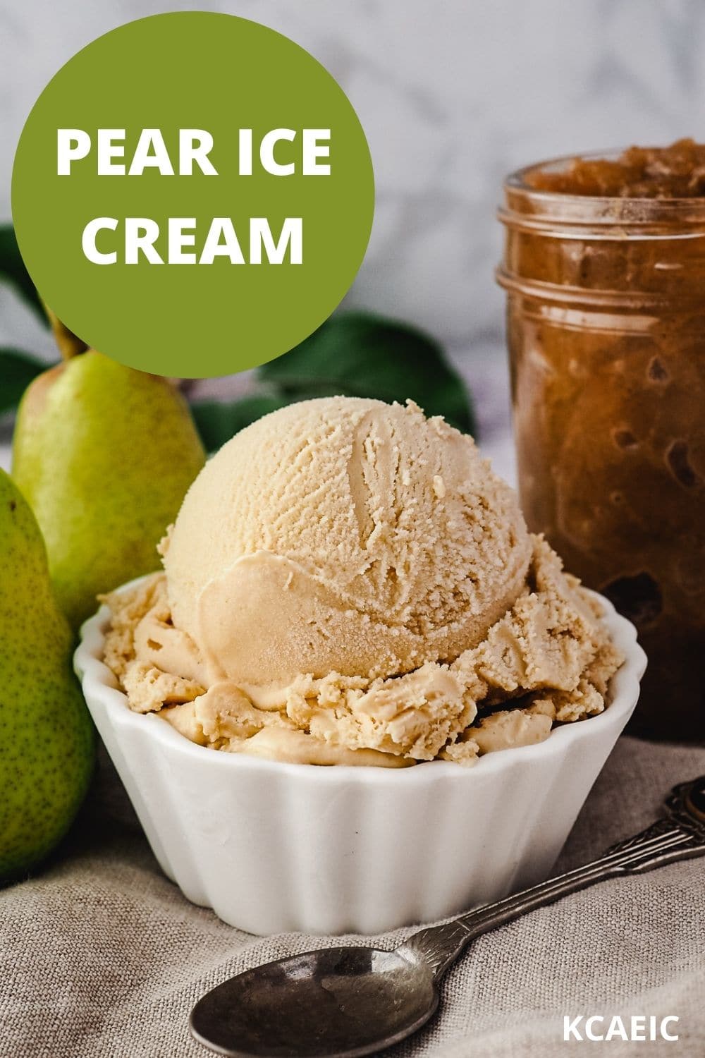 Pear ice cream 10 Scoop of pear ice cream with spoon, fresh pears and jar of pear compote on the side.