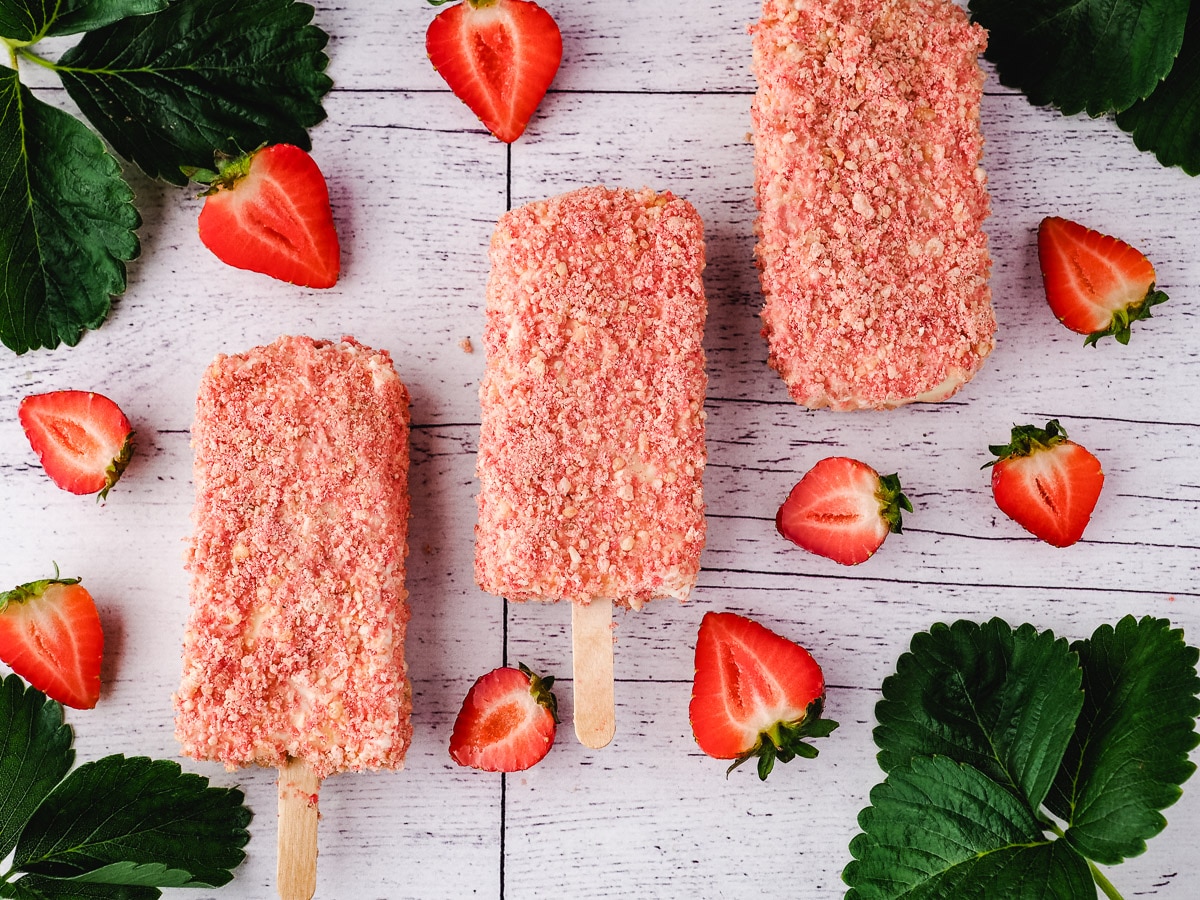 Ice cream bar with fresh strawberries and leaves.