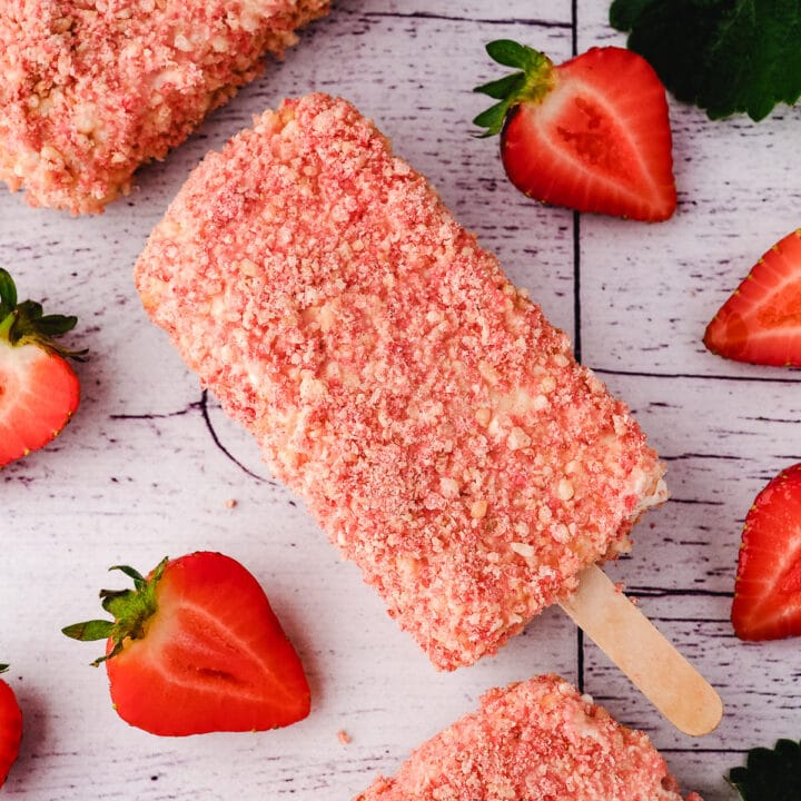 Ice cream bar with fresh strawberries and leaves.