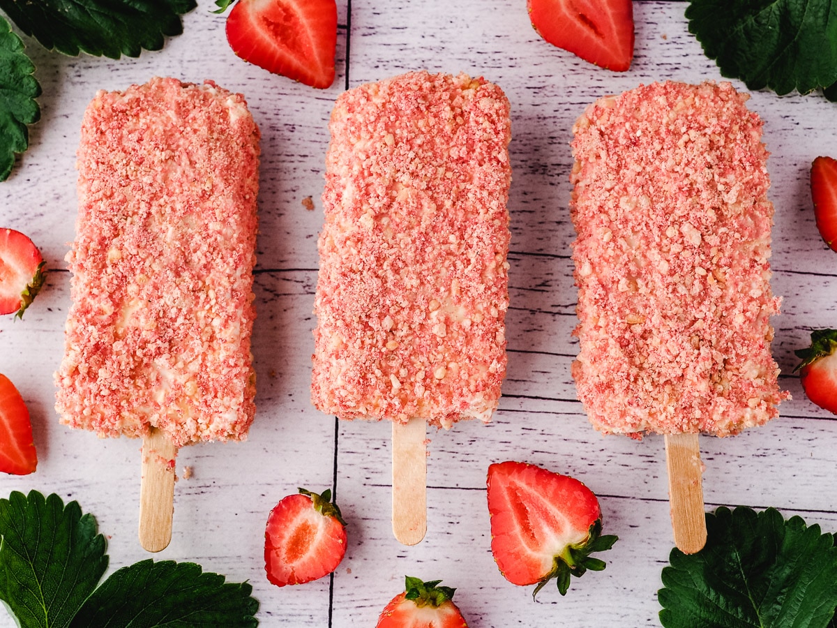 Strawberry Shortcake Ice Cream 10 Ice cream bars with a bite taken out, surrounded by pink and white heart sprinkles.