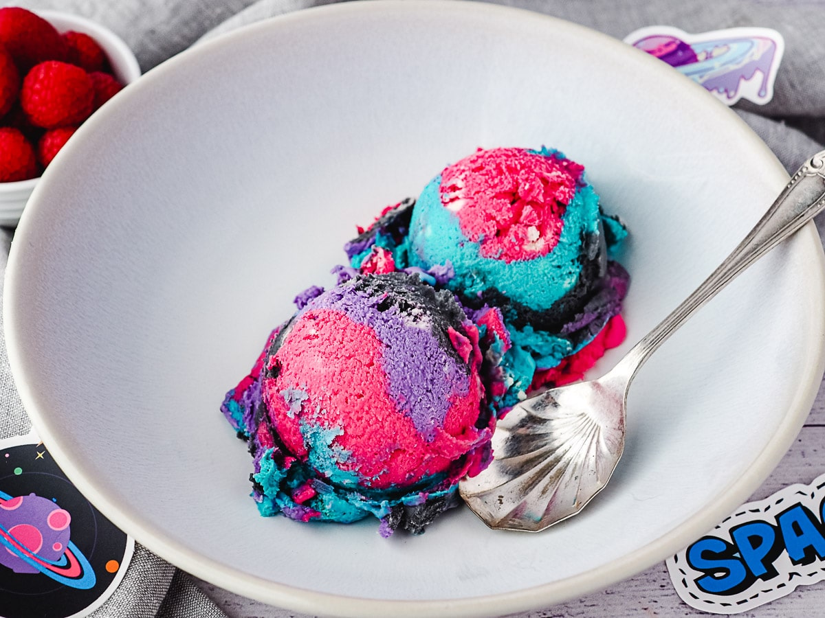 Galaxy Ice Cream 8 Two scoops of ice cream in a bowl with a spoon, surrounded by space stickers.