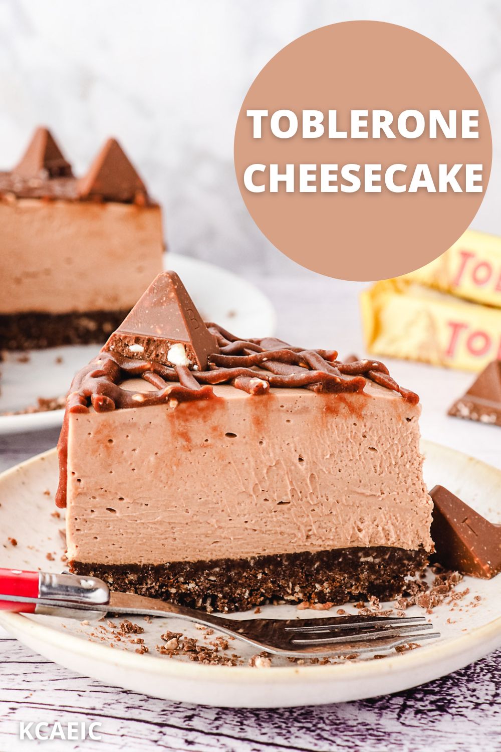Toblerone Cheesecake 12 Slice of Toblerone cheesecake on a plate, with rest of cheesecake and more Toblerone in background, with text overlay.