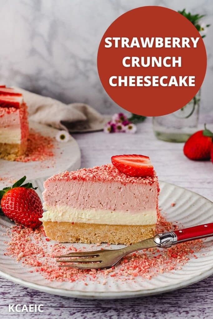 Slice of cheesecake on a plate with a fork, with rest of cake and vase of flowers in background.