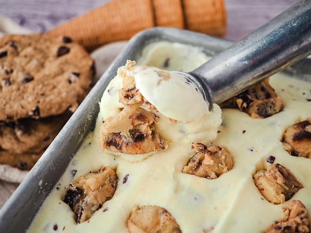 Scooping ice cream from a tub.