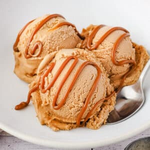 Dulce De Leche Ice Cream 9 Close up three scoops dulce de leche ice cream with drizzle.