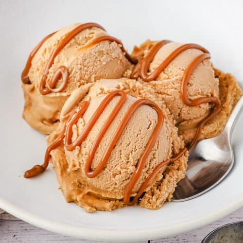 Close up three scoops dulce de leche ice cream with drizzle.