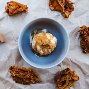 Scoop of hokey pokey ice cream with caramel sauce and fresh honeycomb.