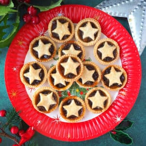 Plate of mincemeat tarts with Christmas decorations.