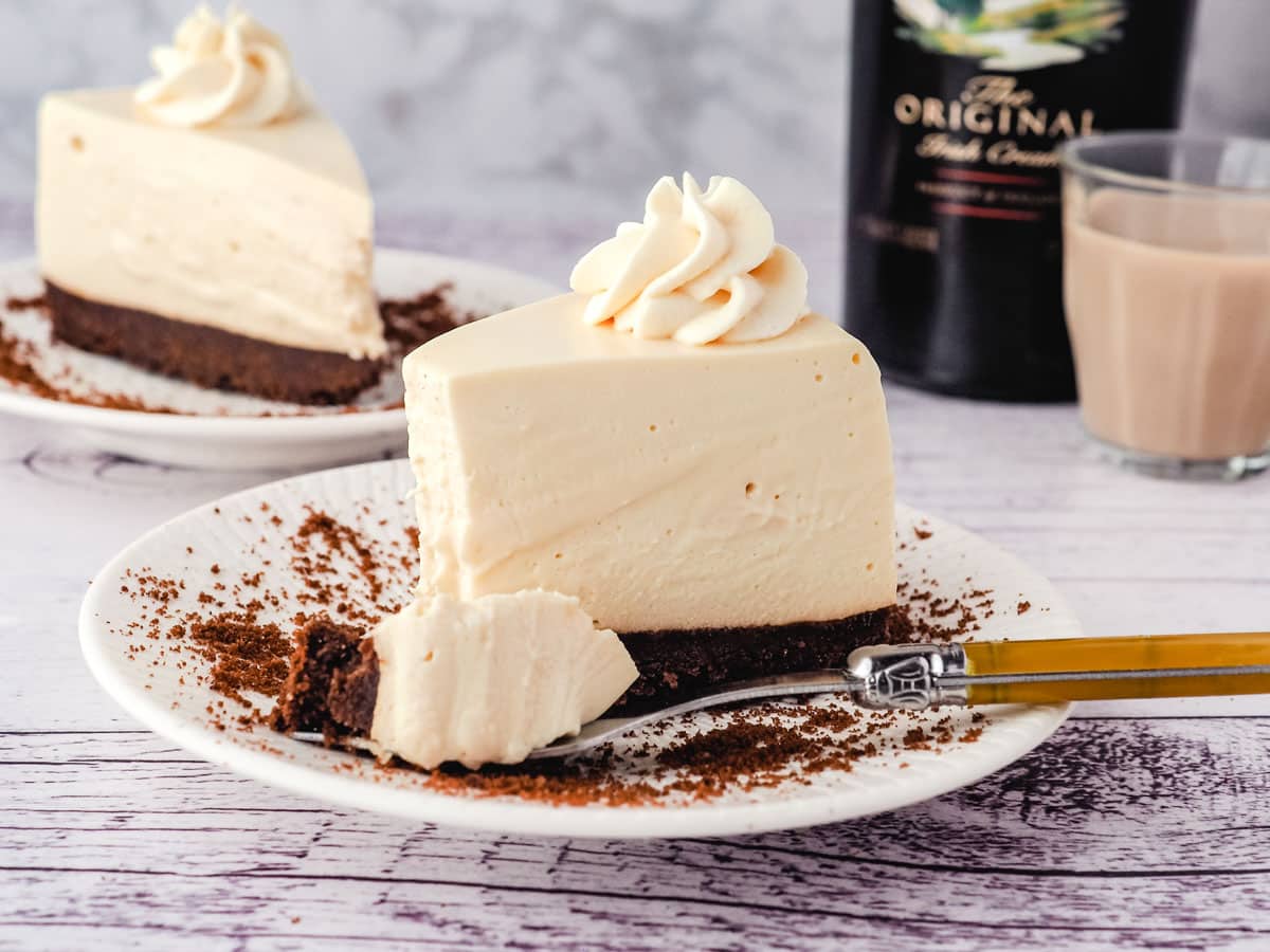 No Bake Baileys Cheesecake 10 Slice of Baileys cheesecake on a plate with a forkful taken out.