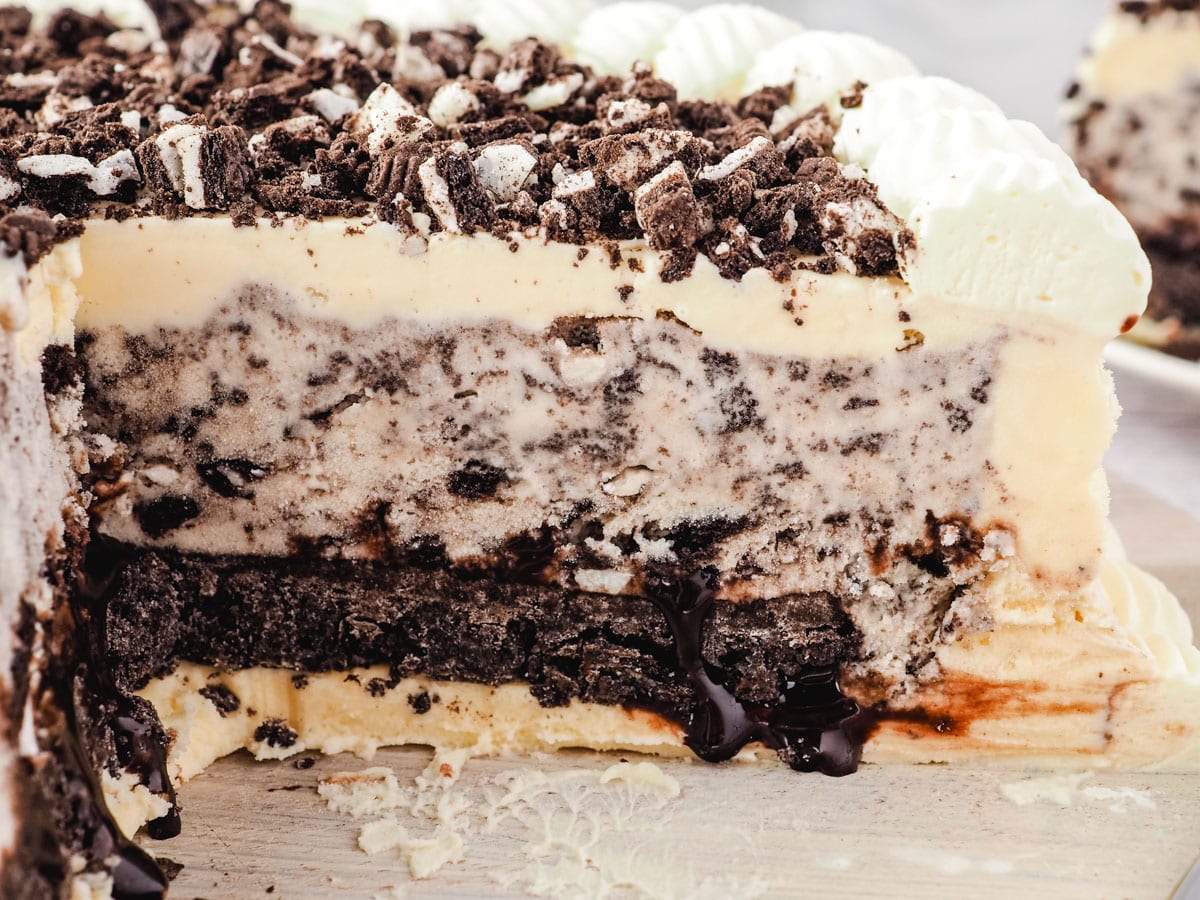 Close up of the inside of the Oreo ice cream cake showing chocolate fudge sauce oozing out.