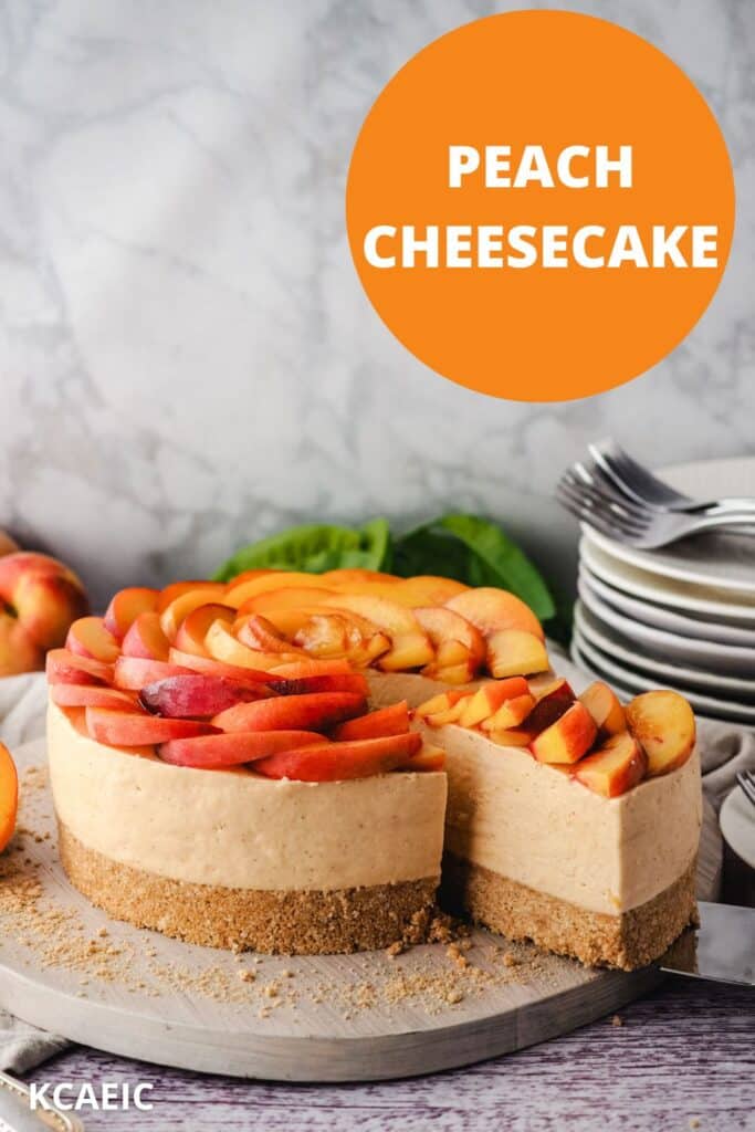 Removing a slice of peach cheesecake from the cake, with a pile of plates and forks in the background and text overlay, peach cheesecake and KCAEIC.