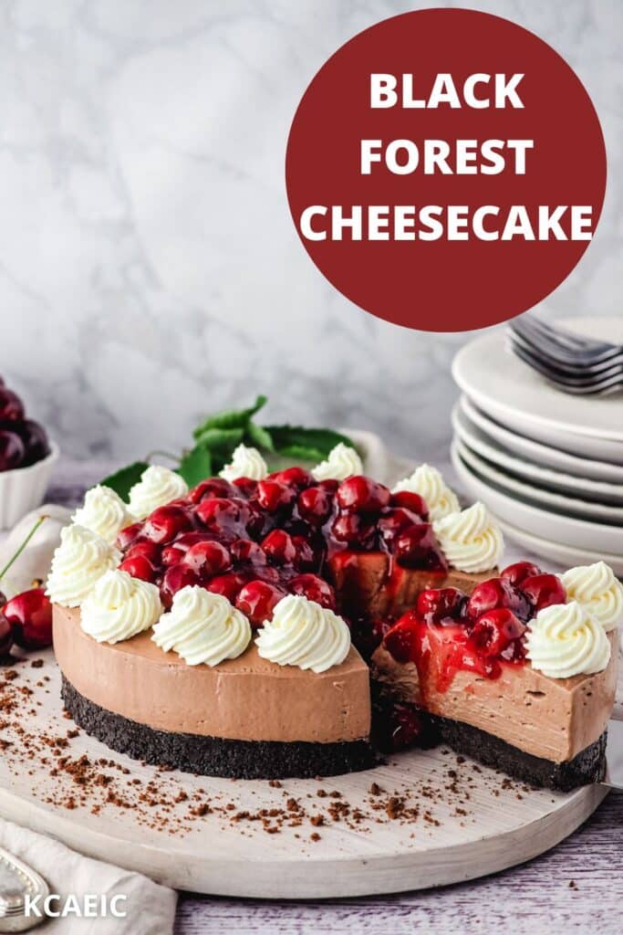 Taking a slice out of a black forest cheesecake, with a stack of plates in the background.