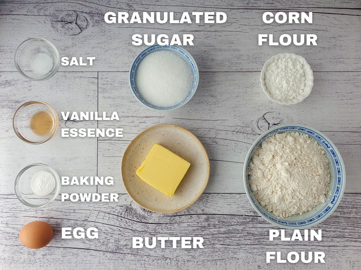 Ingredients, plain flour, corn flour, butter, granulated sugar, egg, baking powder, vanilla essence, salt.