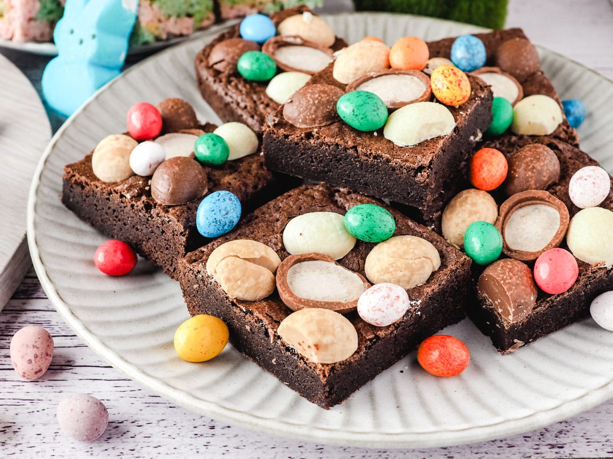 Easter brownie on a plate with extra Easter eggs.