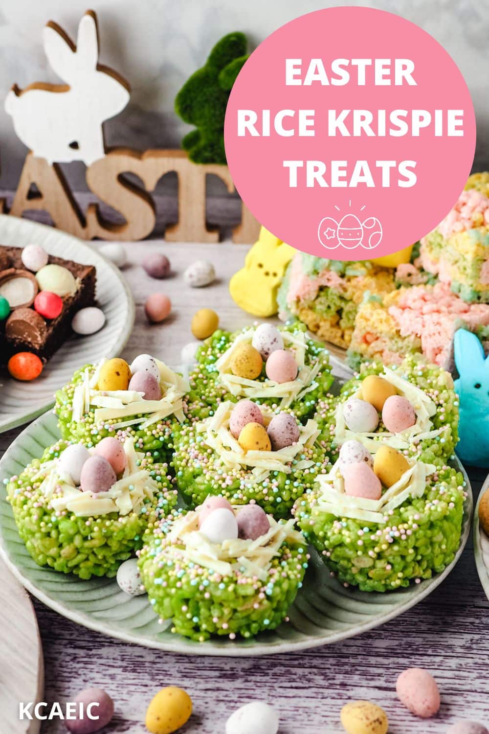 Easter rice krispie treats on a plate surrounded by Easter desserts and Easter decorations.