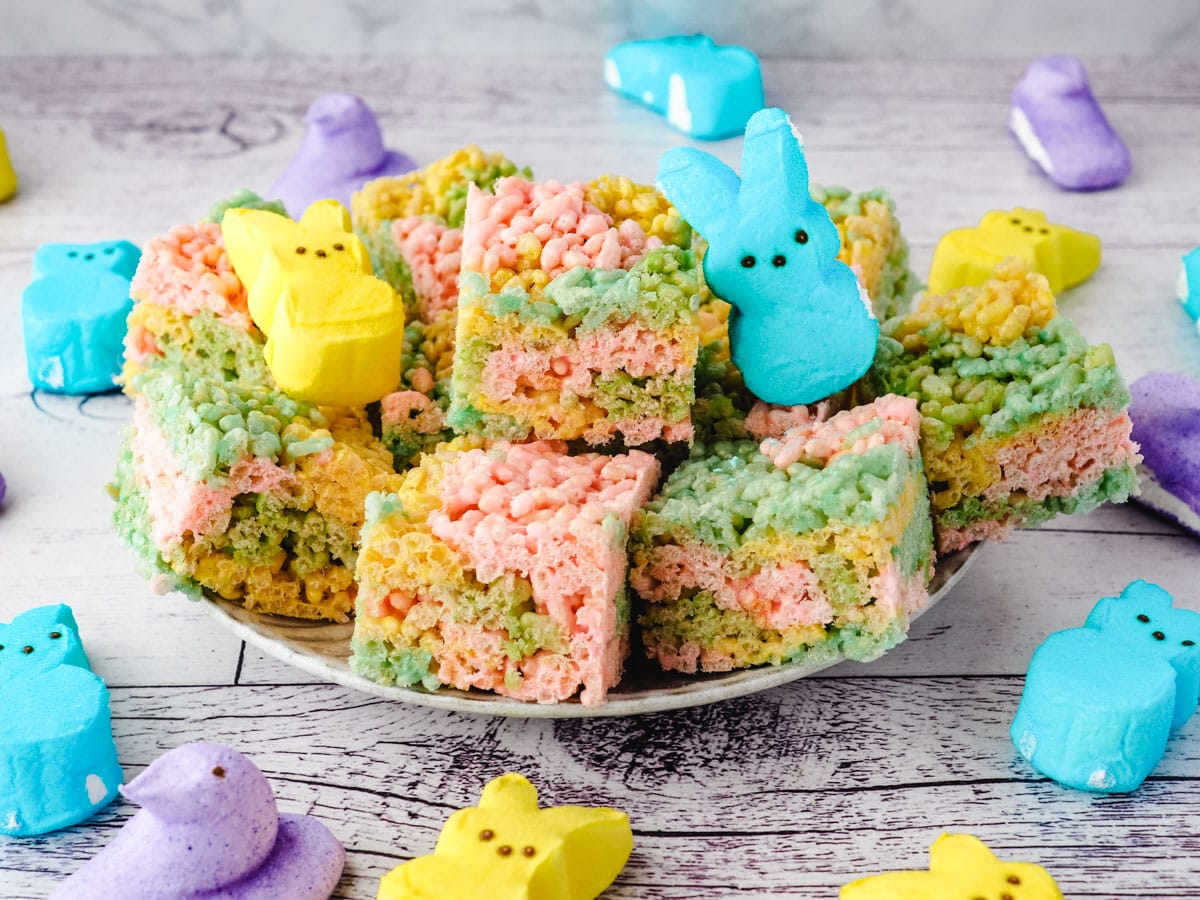 Peeps rice krispie treats on a plate with Peeps on the side.