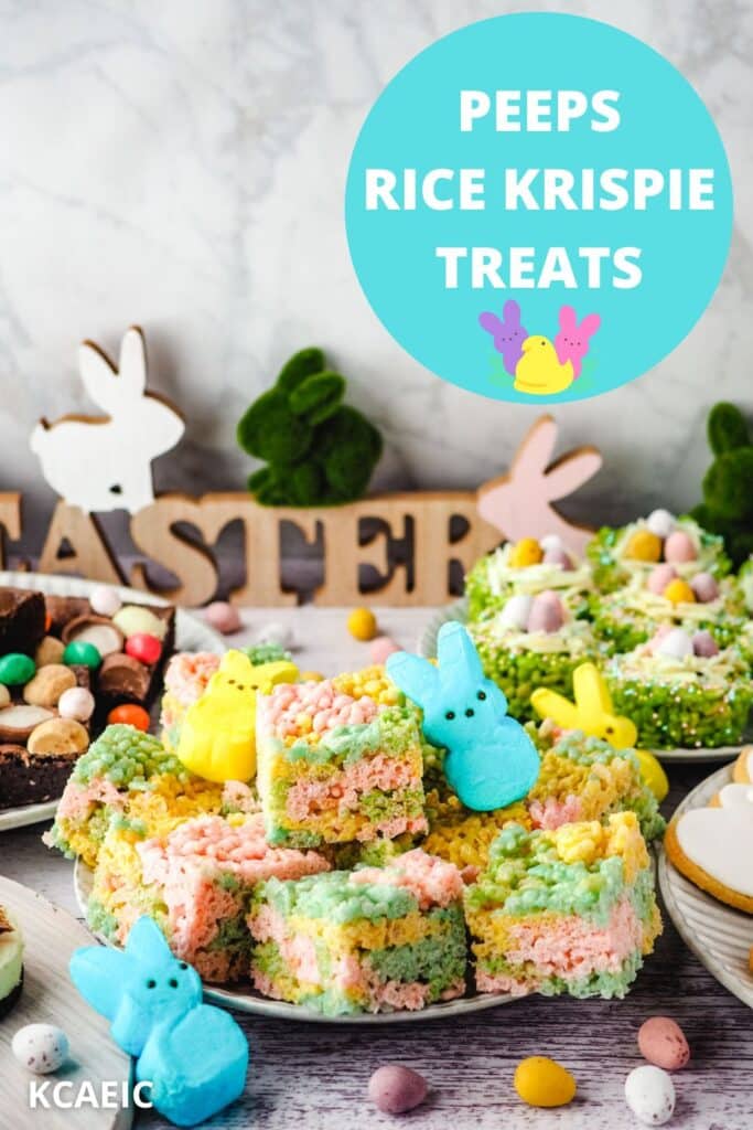 Peeps rice krispie treats on a plate with Peeps on the side, surrounded by Easter desserts and Easter decorations.