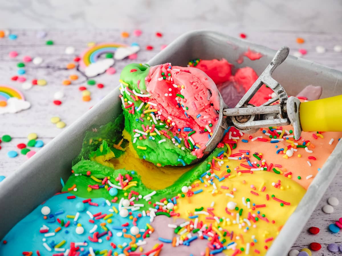 Scooping rainbow ice cream.