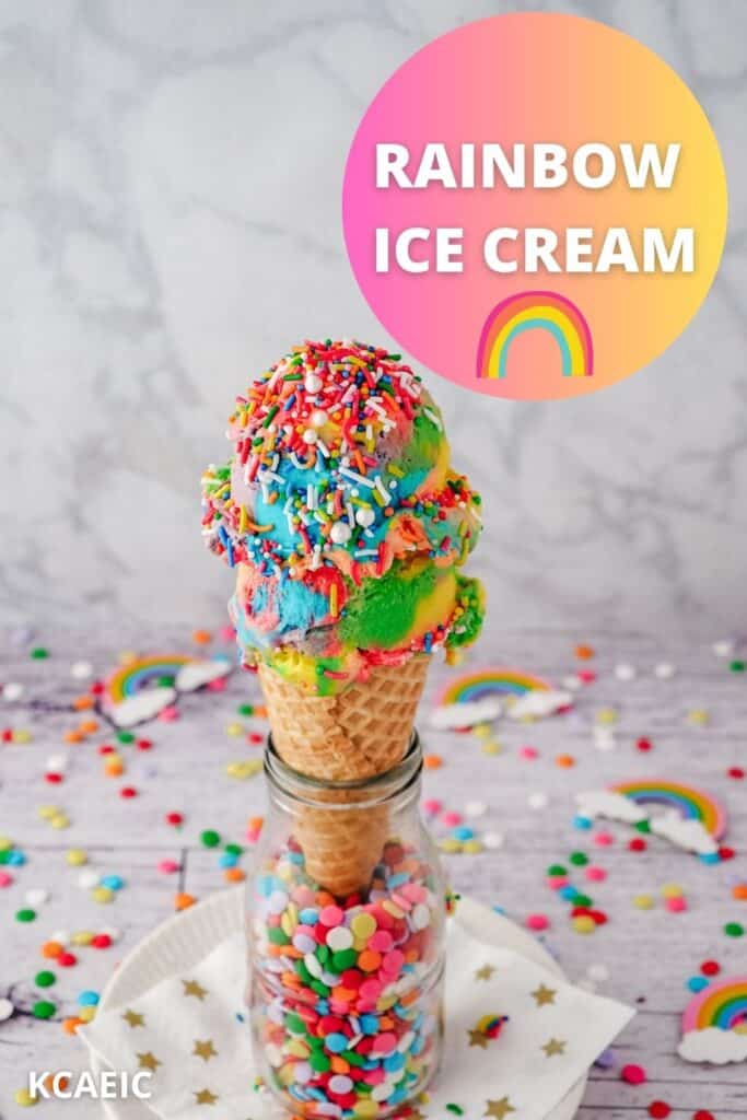 Two scoops of rainbow ice cream with rainbow sprinkles in an ice cream cone.