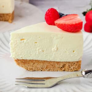 No Bake Cheesecake Recipes 34 No bake cheesecake recipes, slice of base recipe, on a plate with a fork and fresh fruit.