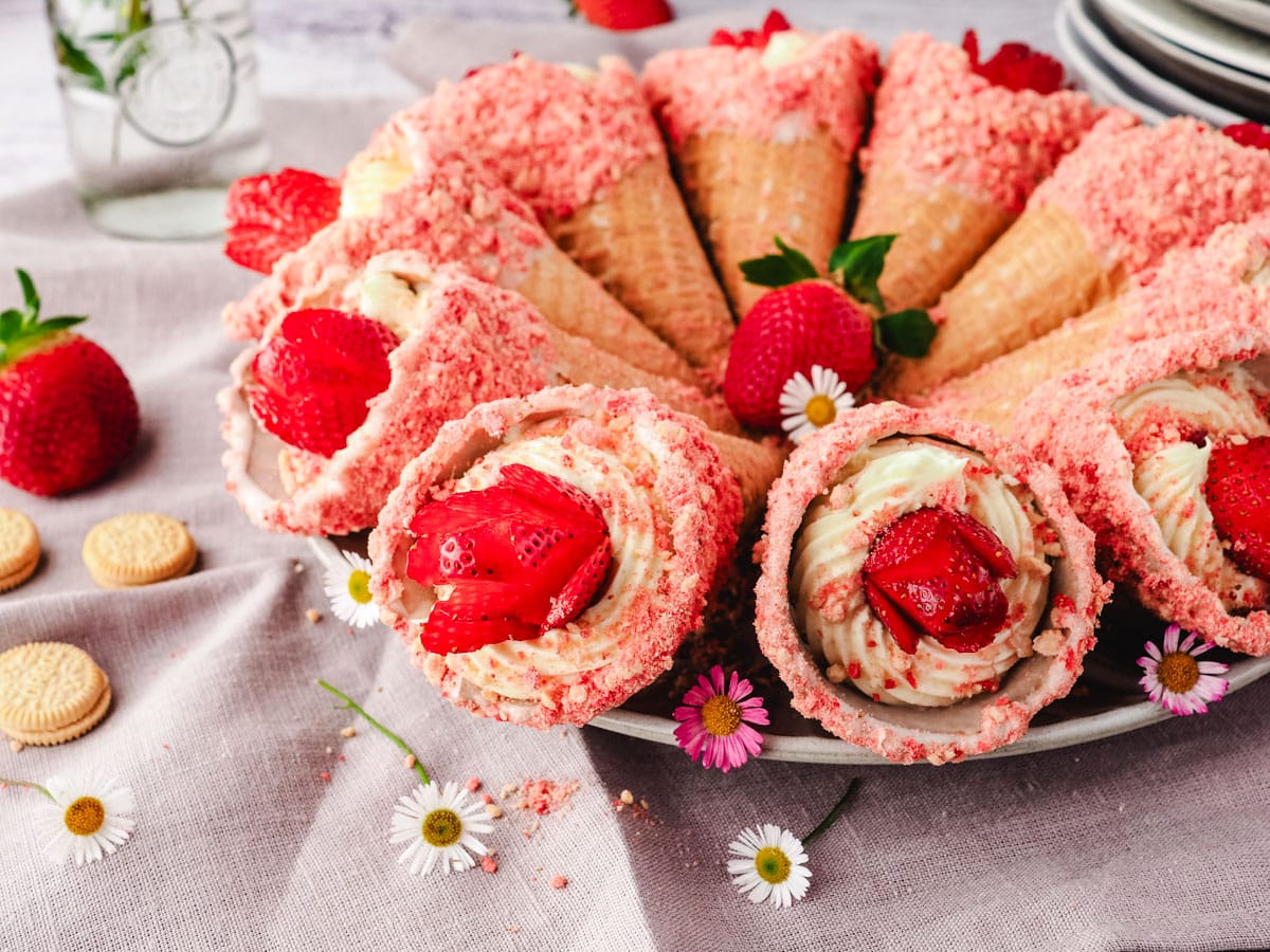 Serving plate of strawberry shortcake cones with cheesecake filling.