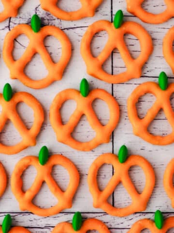 Close up of pumpkin pretzels on a white background.