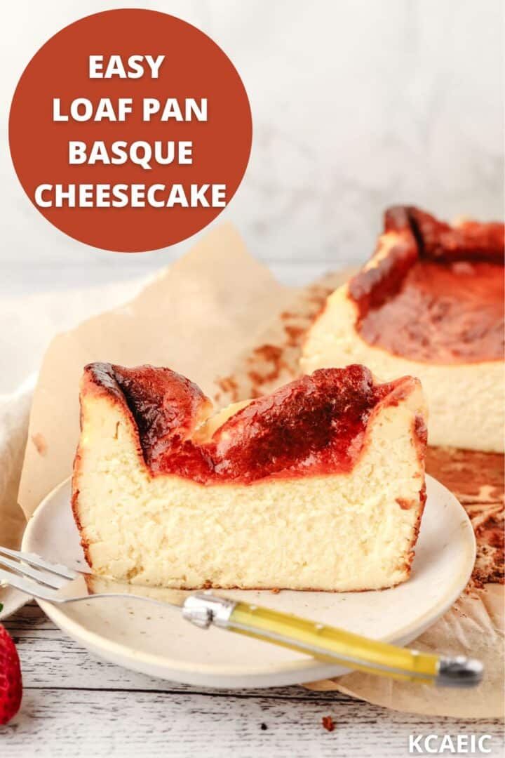 Slice of loaf pan Basque cheesecake on a plate with a fork and the rest of the cheesecake in the background with text overlay.
