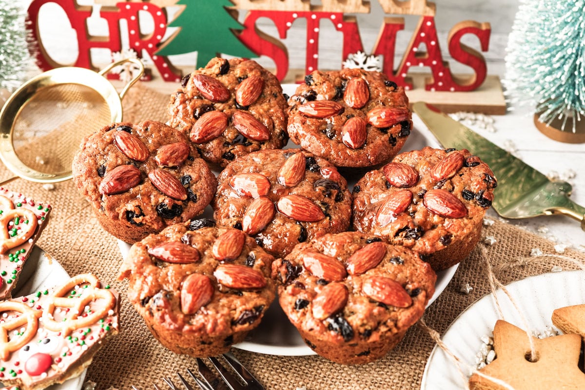 Mini Christmas cakes on a serving platter on a festive dessert table.